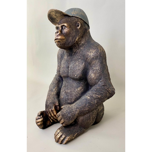 579 - GORILLA WITH HIS BASEBALL CAP, contemporary school sculptural study, faux bronze, 54cm H.