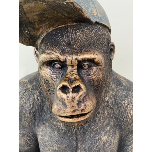 579 - GORILLA WITH HIS BASEBALL CAP, contemporary school sculptural study, faux bronze, 54cm H.