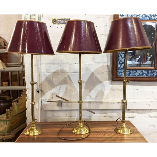 179 - TABLE LAMPS, each approx 75cm H including shades, three, adjustable, slender brass columns. (3)