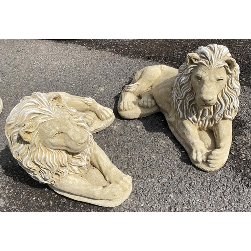 596 - RECUMBENT LIONS, a pair, composite stone, 35cm H x 60cm x 35cm. (2)