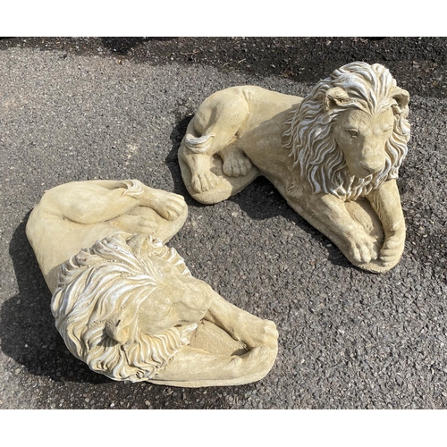 596 - RECUMBENT LIONS, a pair, composite stone, 35cm H x 60cm x 35cm. (2)