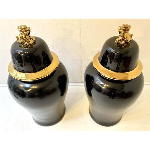 520 - CHINESE TEMPLE URNS, a pair, glazed ceramic with a black and gilt finish, 82x39x39. (2)