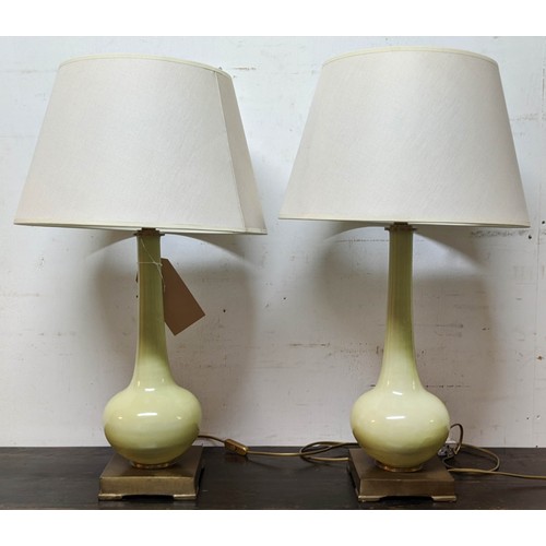 560 - TABLE LAMPS, a pair, 70cm H celadon green coloured, each with a white shade. (2)