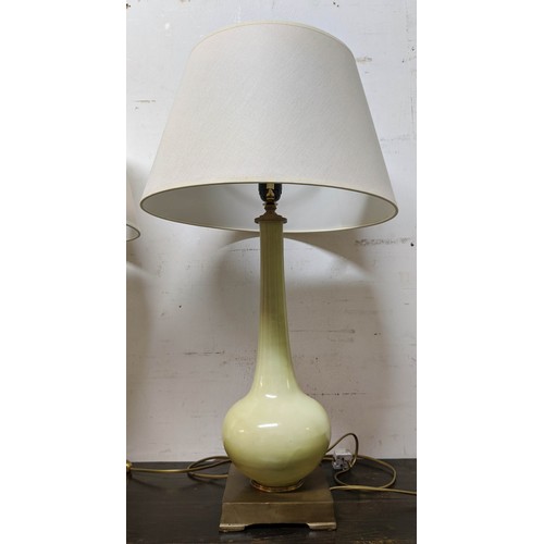 560 - TABLE LAMPS, a pair, 70cm H celadon green coloured, each with a white shade. (2)