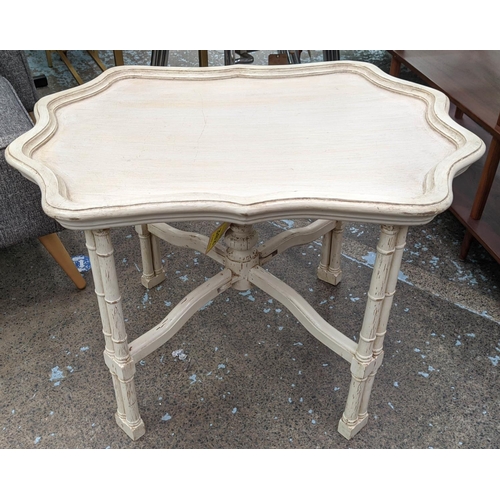 564 - LOW TABLE, 20th century, cream painted on wood, distressed, shaped tray top with pie crust edge, fol... 