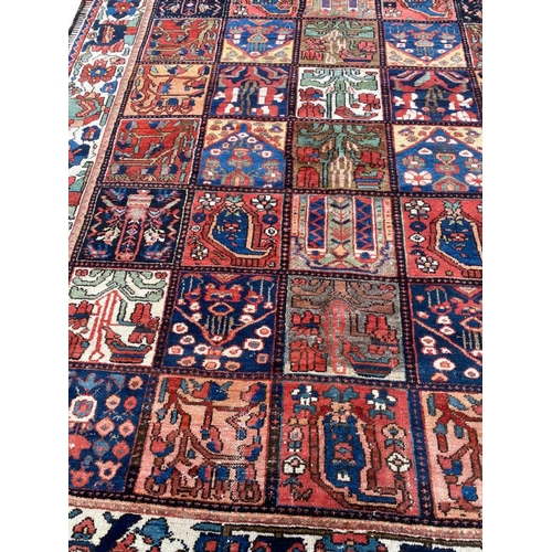 99 - ANTIQUE BAKTIARI CARPET, 310cm x 220cm.