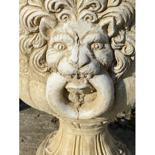 634 - GARDEN PEDESTAL URNS, a pair, Regency style, composite stone, twin handled with cast decoration, 67c... 