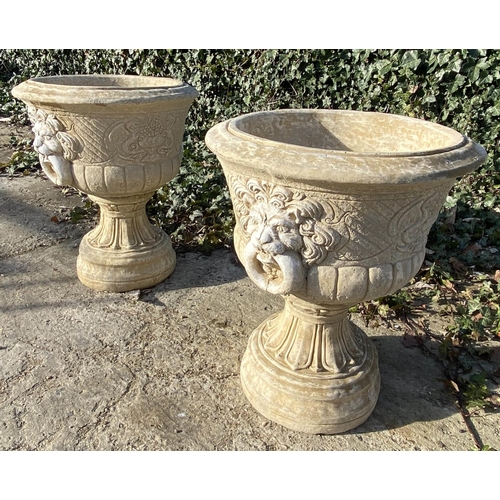 634 - GARDEN PEDESTAL URNS, a pair, Regency style, composite stone, twin handled with cast decoration, 67c... 