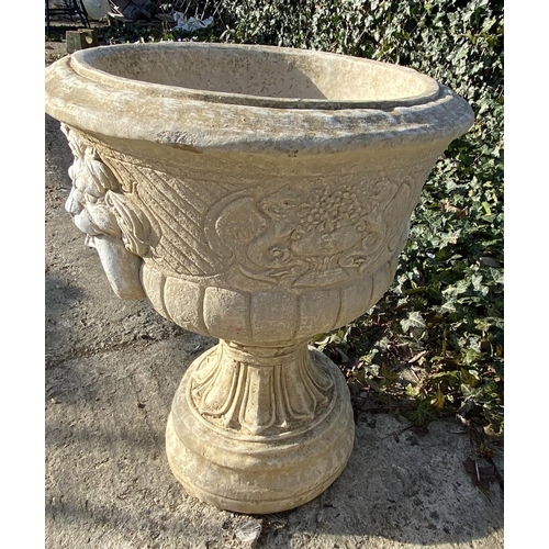 634 - GARDEN PEDESTAL URNS, a pair, Regency style, composite stone, twin handled with cast decoration, 67c... 