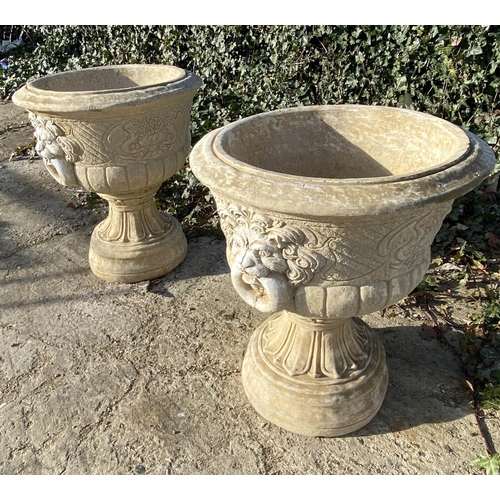 634 - GARDEN PEDESTAL URNS, a pair, Regency style, composite stone, twin handled with cast decoration, 67c... 