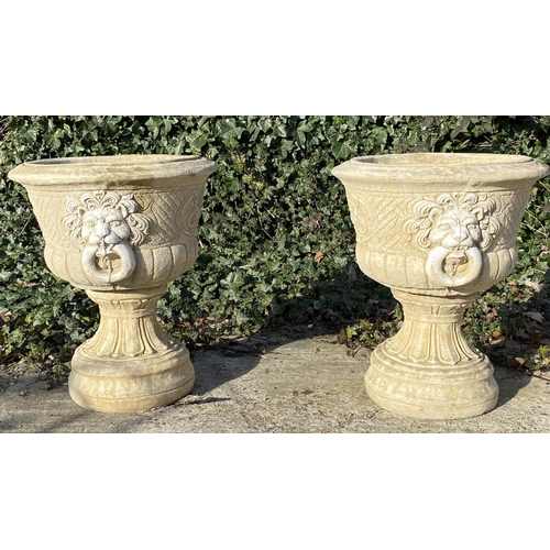 634 - GARDEN PEDESTAL URNS, a pair, Regency style, composite stone, twin handled with cast decoration, 67c... 