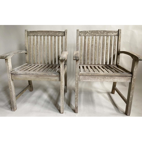 159 - GARDEN ARMCHAIRS, a pair, nicely weathered slatted teak with curved arms and a low X frame table by ... 