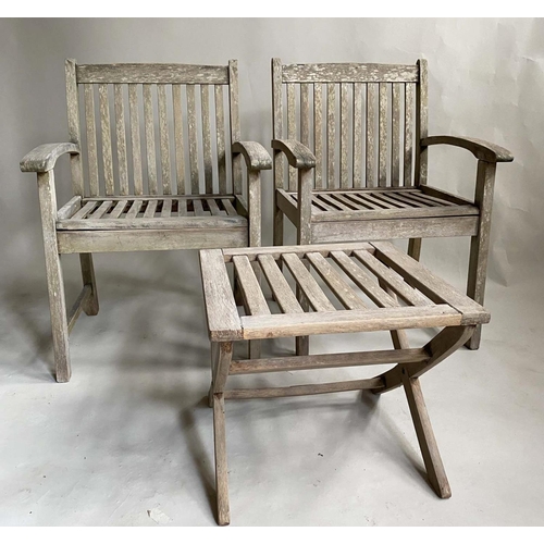 159 - GARDEN ARMCHAIRS, a pair, nicely weathered slatted teak with curved arms and a low X frame table by ... 