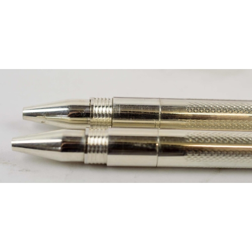 4 - PROPELLING PENS, two boxed sets, each comprising two silver propelling pens, two with fluted bodies,... 