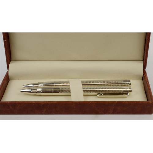 4 - PROPELLING PENS, two boxed sets, each comprising two silver propelling pens, two with fluted bodies,... 