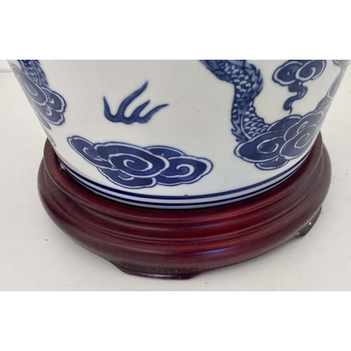 480 - CHINESE DRAGON URNS AND COVERS, 38cm x 22cm, blue and white under glaze decoration, with stands. (2)