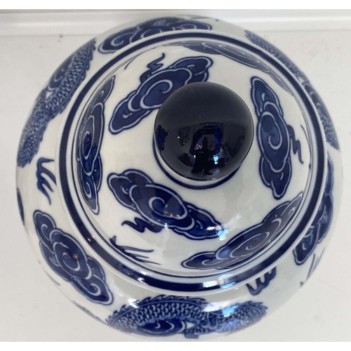 480 - CHINESE DRAGON URNS AND COVERS, 38cm x 22cm, blue and white under glaze decoration, with stands. (2)