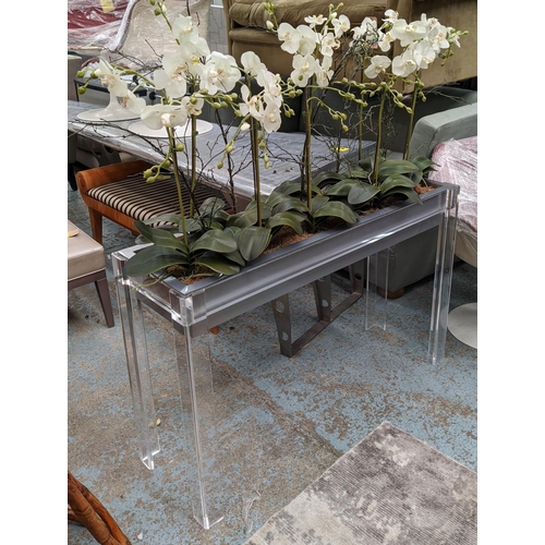 629 - PERSPEX JARDINIERE, 39cm D x 80cm H x 123cm W, with faux orchids.