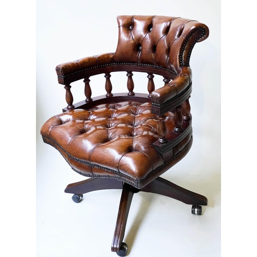 658 - REVOLVING DESK CHAIR, vintage buttoned tan leather, revolving and reclining on a base with castors.