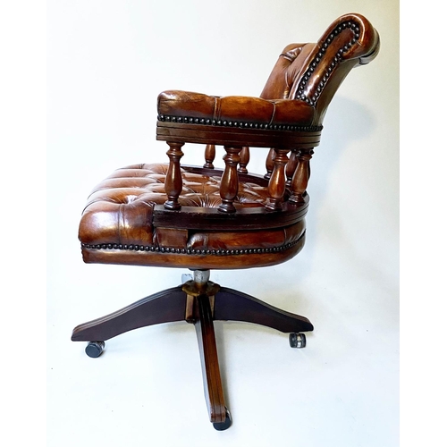 658 - REVOLVING DESK CHAIR, vintage buttoned tan leather, revolving and reclining on a base with castors.