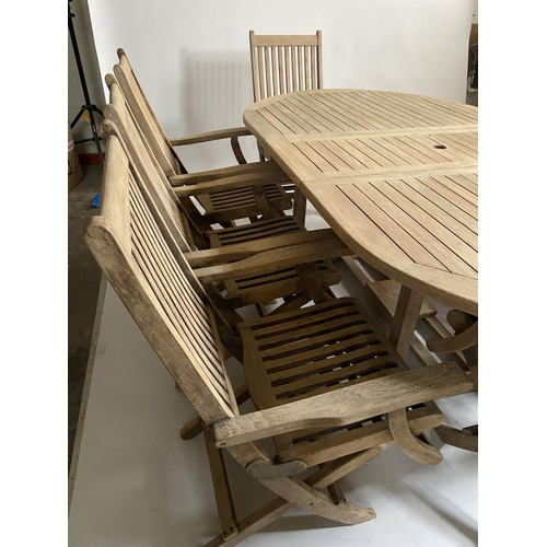 206 - GARDEN TABLE AND CHAIRS, weathered teak rounded rectangular slatted 75cm H x 119cm x 210cm L with ei... 