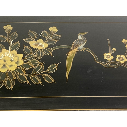 137 - SIDE CABINET, Chinese black lacquer with gilt Chinoiserie decoration and two doors, 71cm x 31cm x 10... 