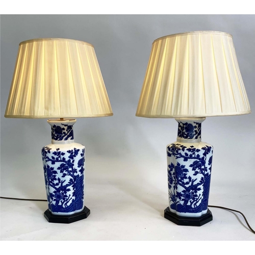 151 - TABLE LAMPS, a pair, blue and white Chinese style ceramic of facetted vase form with pleated shades,... 