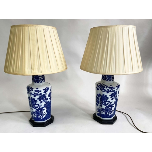 151 - TABLE LAMPS, a pair, blue and white Chinese style ceramic of facetted vase form with pleated shades,... 