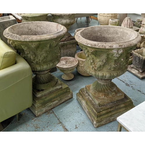 371 - ARCHITECTURAL GARDEN URNS, a pair, 86cm x 58cm diam, composite stone with swag and rams head detail.... 