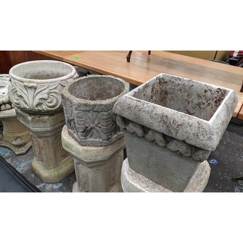 376 - ARCHITECTURAL GARDEN PEDESTALS, a set of three, 100cm at tallest, each with differing planter, compo... 