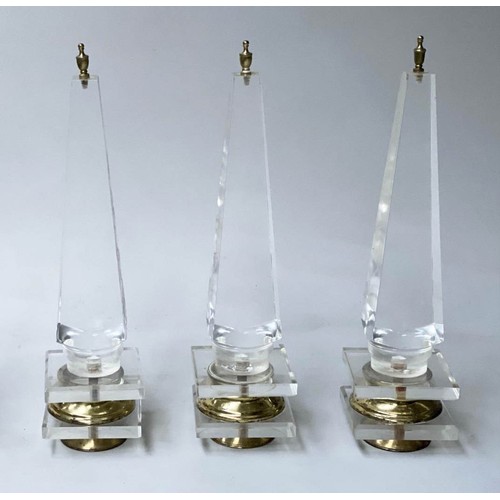 615 - TABLE OBELISKS, a set of three, 42cm H, Lucite, of tapering form on gilded bases. (3)