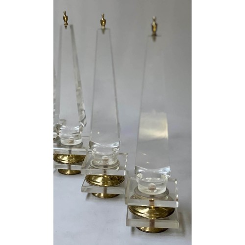 615 - TABLE OBELISKS, a set of three, 42cm H, Lucite, of tapering form on gilded bases. (3)