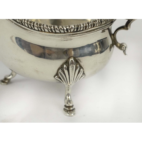 31 - SAUCE BOAT, Georgian style, silver helmet shaped, Birmingham 1929, acanthus cast handle, three hoof ... 