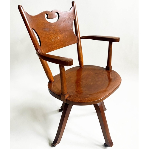 582 - OFFICE CHAIR, 1920's Art Nouveau influenced, carved oak with pierced back, shaped seat revolving on ... 