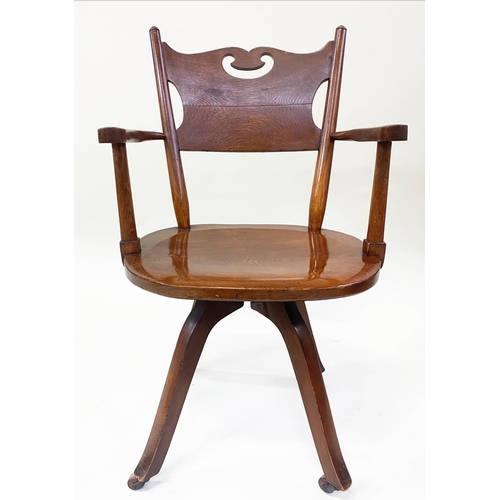 582 - OFFICE CHAIR, 1920's Art Nouveau influenced, carved oak with pierced back, shaped seat revolving on ... 