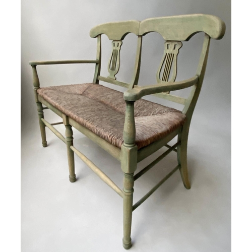 595 - HALL BENCH, vintage, green stained, with raised lyre back and rush seat, 114cm W.