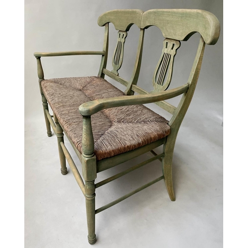 595 - HALL BENCH, vintage, green stained, with raised lyre back and rush seat, 114cm W.