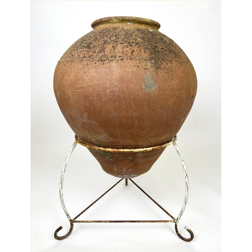 127 - TERRACOTTA OLIVE JAR, of substantial size, early 20th century on wrought iron stand, 94cm H.