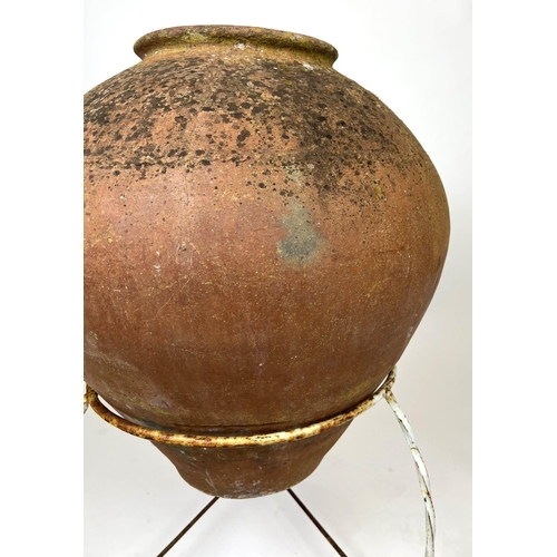 127 - TERRACOTTA OLIVE JAR, of substantial size, early 20th century on wrought iron stand, 94cm H.