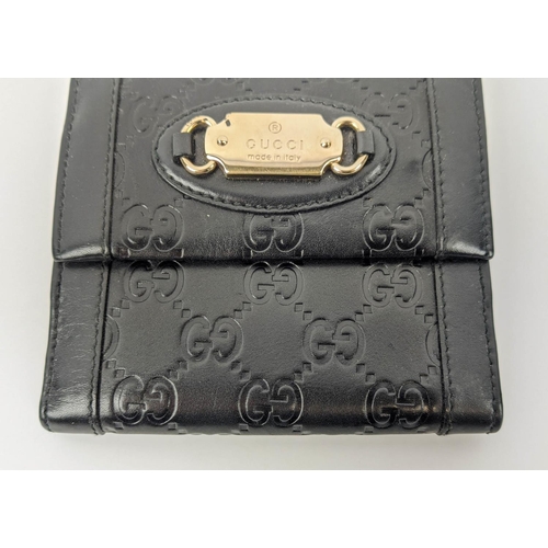 22 - GUCCI EMBOSSED WALLET, with front logo plaque, snap closure, double rear compartments for notes, car... 