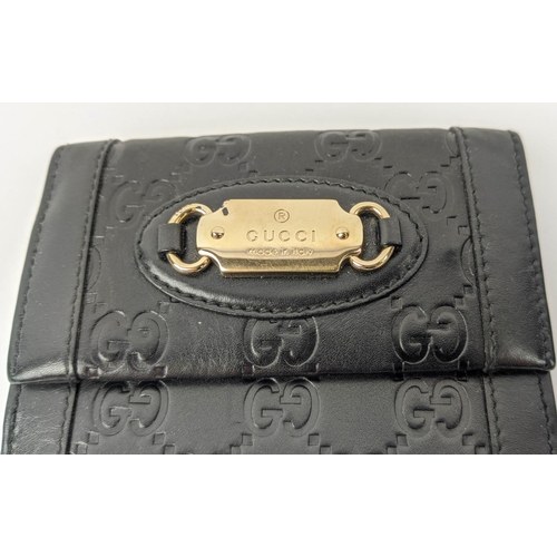 22 - GUCCI EMBOSSED WALLET, with front logo plaque, snap closure, double rear compartments for notes, car... 