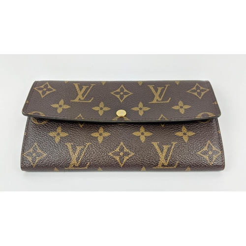 26 - LOUIS VUITTON MONOGRAM WALLET, with a central zipped coin pocket, multiple card slots, two large com... 