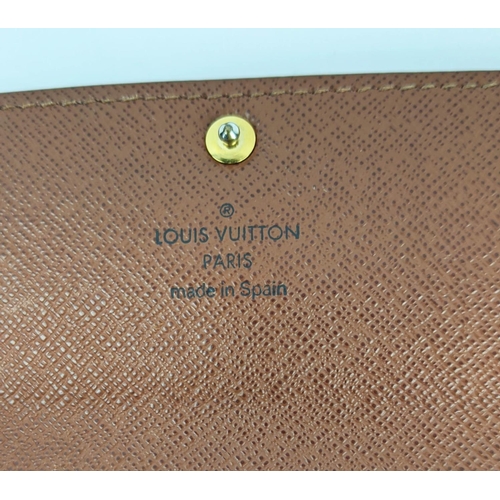 26 - LOUIS VUITTON MONOGRAM WALLET, with a central zipped coin pocket, multiple card slots, two large com... 