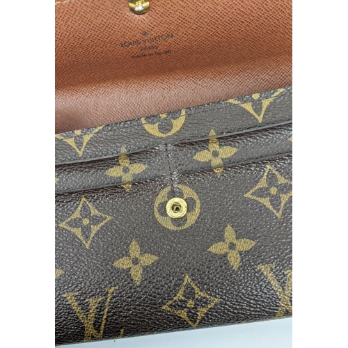 26 - LOUIS VUITTON MONOGRAM WALLET, with a central zipped coin pocket, multiple card slots, two large com... 