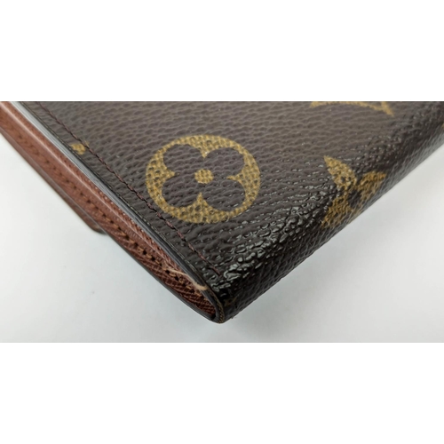 26 - LOUIS VUITTON MONOGRAM WALLET, with a central zipped coin pocket, multiple card slots, two large com... 