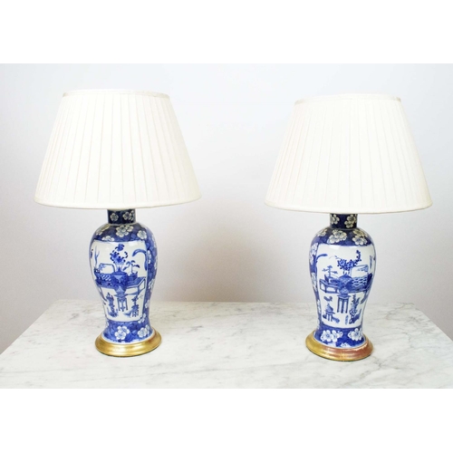 14 - LAMPS, a pair, Chinese blue and white on gilt bases with silk pleated shades. (2)