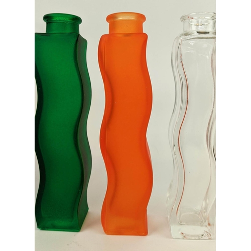 593 - SIX COLOURED BOTTLES, 22cm H, serpentine form and identical shape, late 20th century.