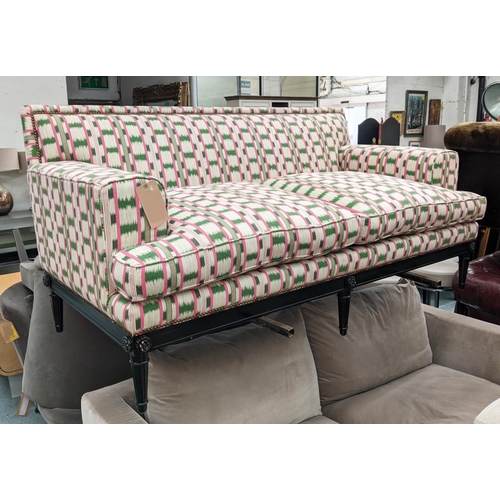 551 - SOFA, 186cm x 93cm D, in a pink and green ikat fabric with studded detail and ebonised base.