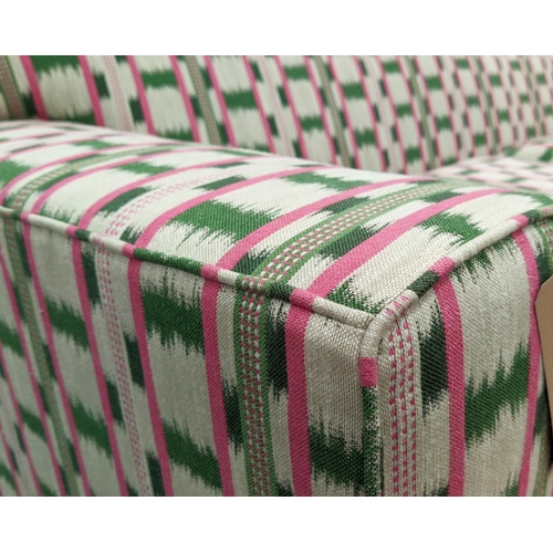 551 - SOFA, 186cm x 93cm D, in a pink and green ikat fabric with studded detail and ebonised base.