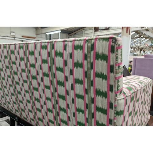 551 - SOFA, 186cm x 93cm D, in a pink and green ikat fabric with studded detail and ebonised base.